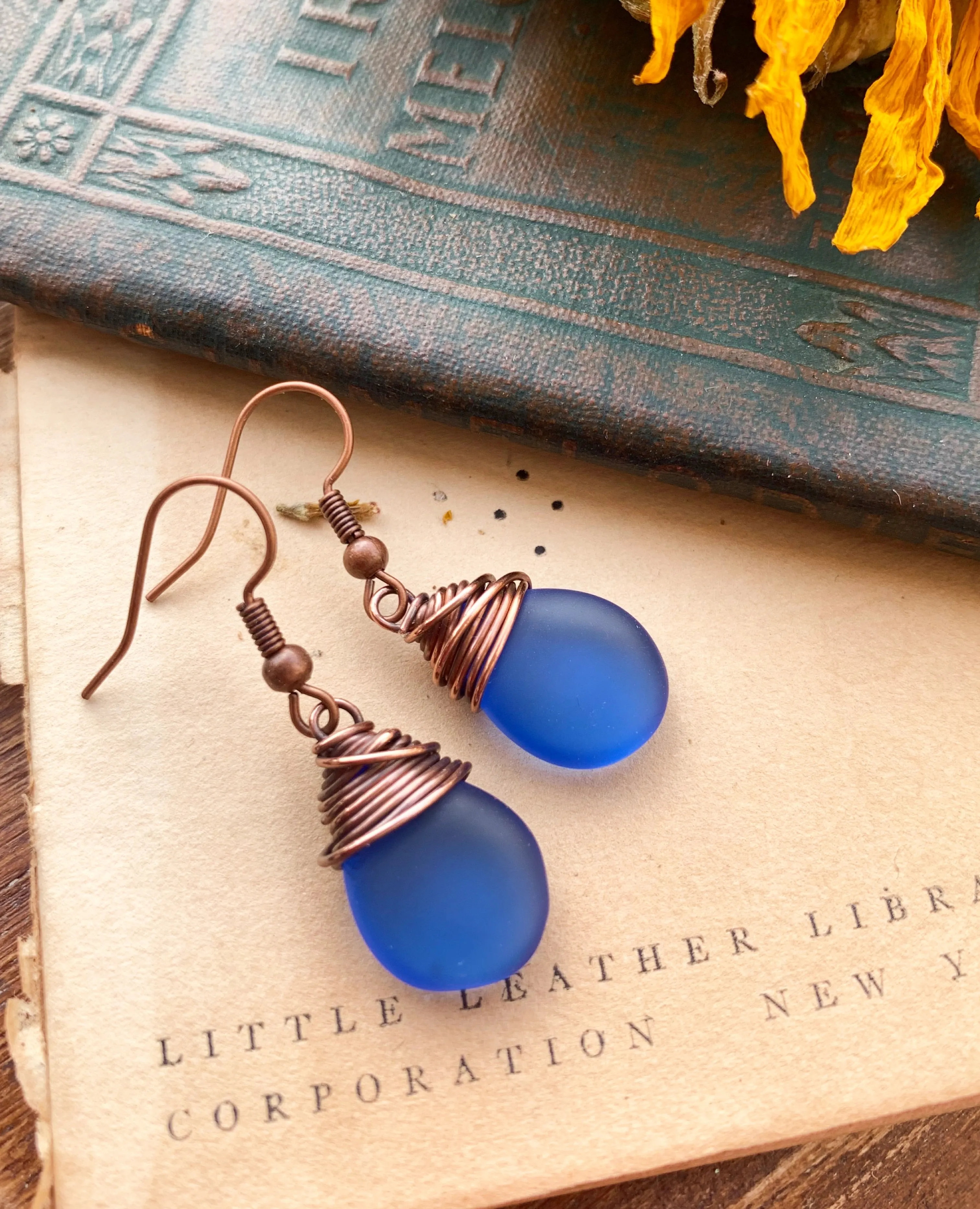 Blue frosted teardrop Czech glass and copper wire wrapped earrings.