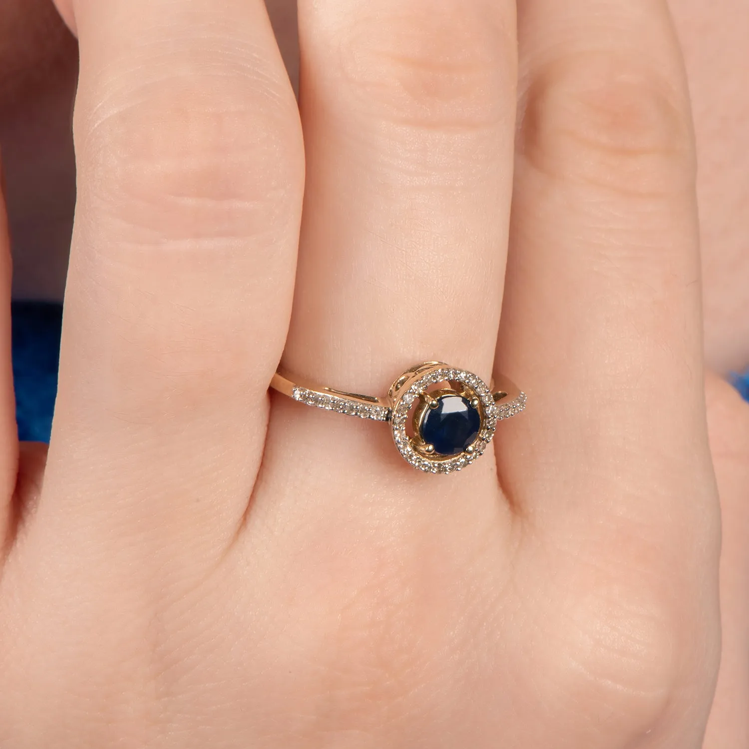 Jewelili 10K Yellow Gold with Round Blue Sapphire and 1/6 CTTW Round Natural White Diamonds Halo Ring